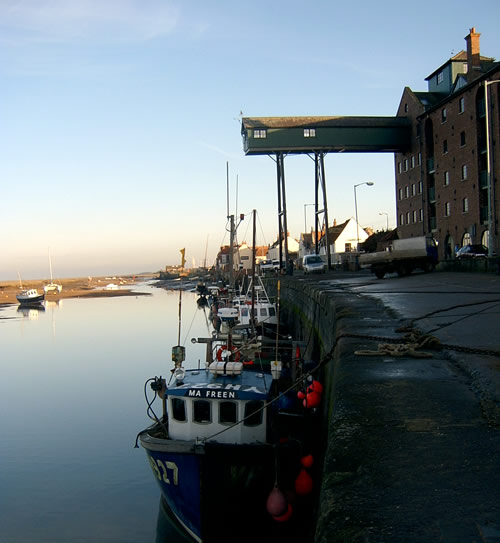 Wells Quay with fishing boats tied up at sunset